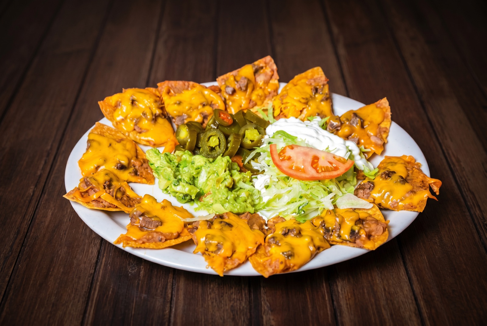 Loaded nachos with beans, cheese, guacamole and sour cream
