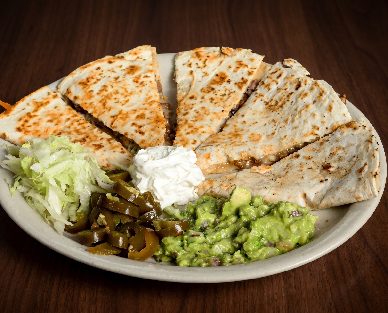 Large quesadilla platter with guacamole in the center