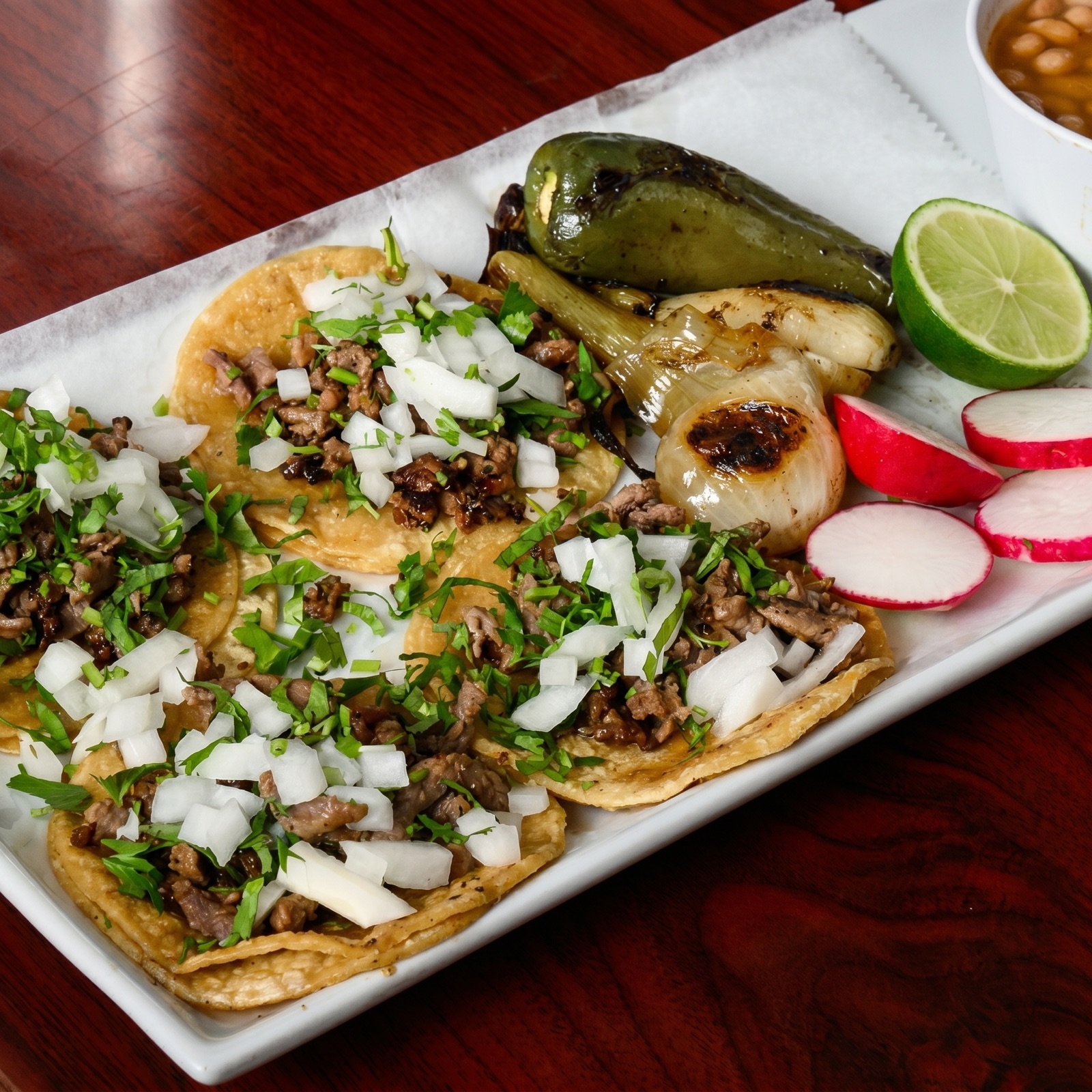 Street-style Mexican tacos with onion, cilantro and radish